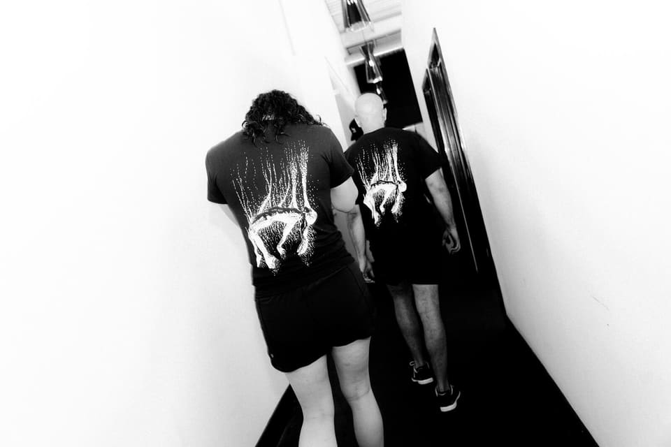 Two members walking down the corridor onto the Kinetic Haus training floor