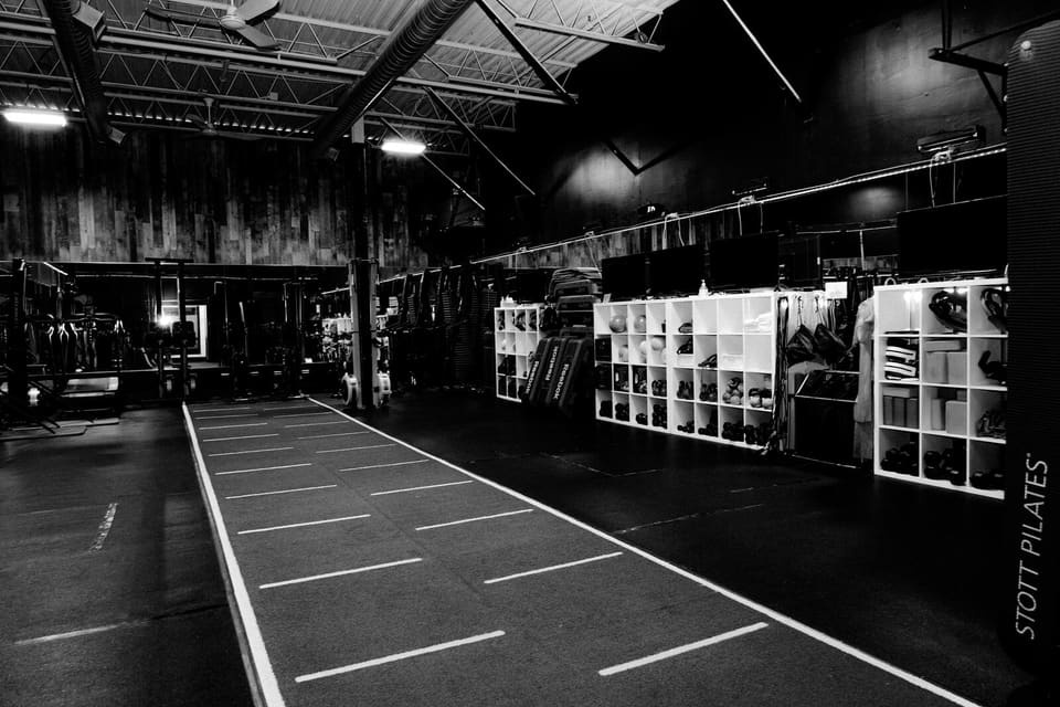 The turf lane and equipment wall on the Kinetic Haus training floor
