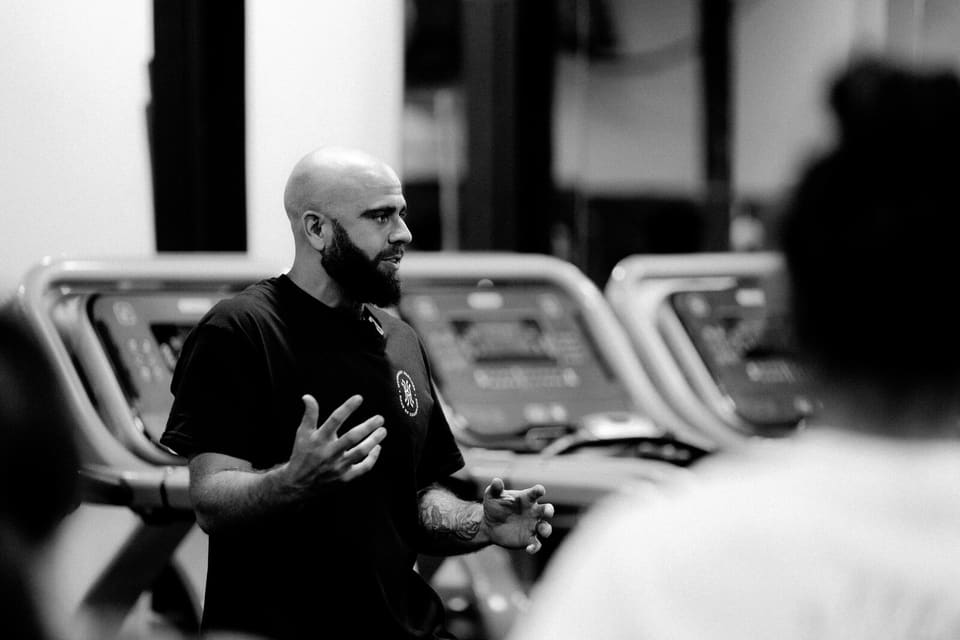 A Kinetic Haus coach explaining a training session